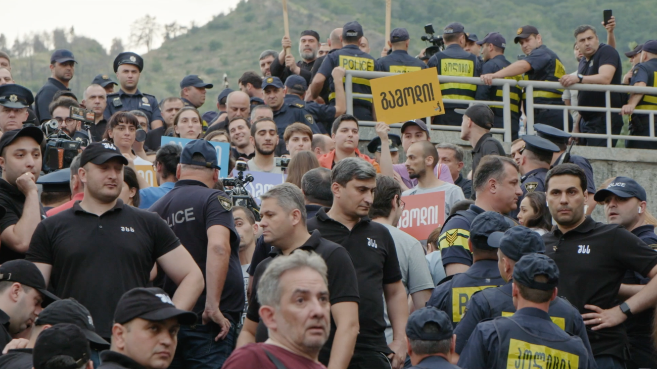 Photo of protesters in the country Georgia holding signs